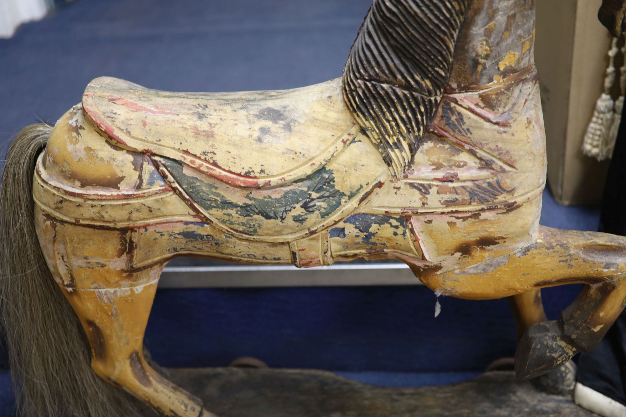 A painted carved wood Merry-go-round horse now in a wheeled base, height 80cm